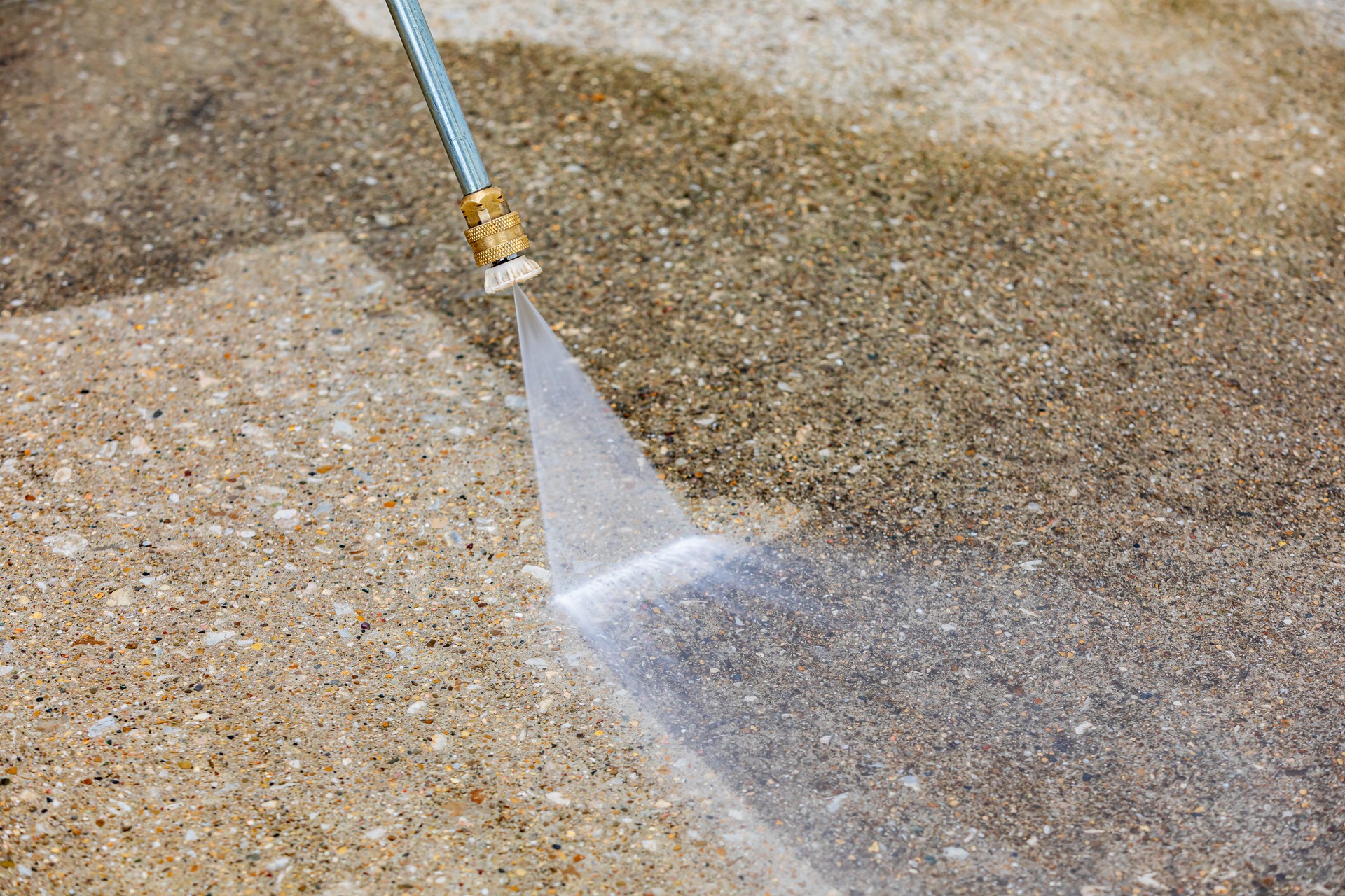 Pressure washing dirty concrete driveway. Home cleaning, maintenance and household chores concept